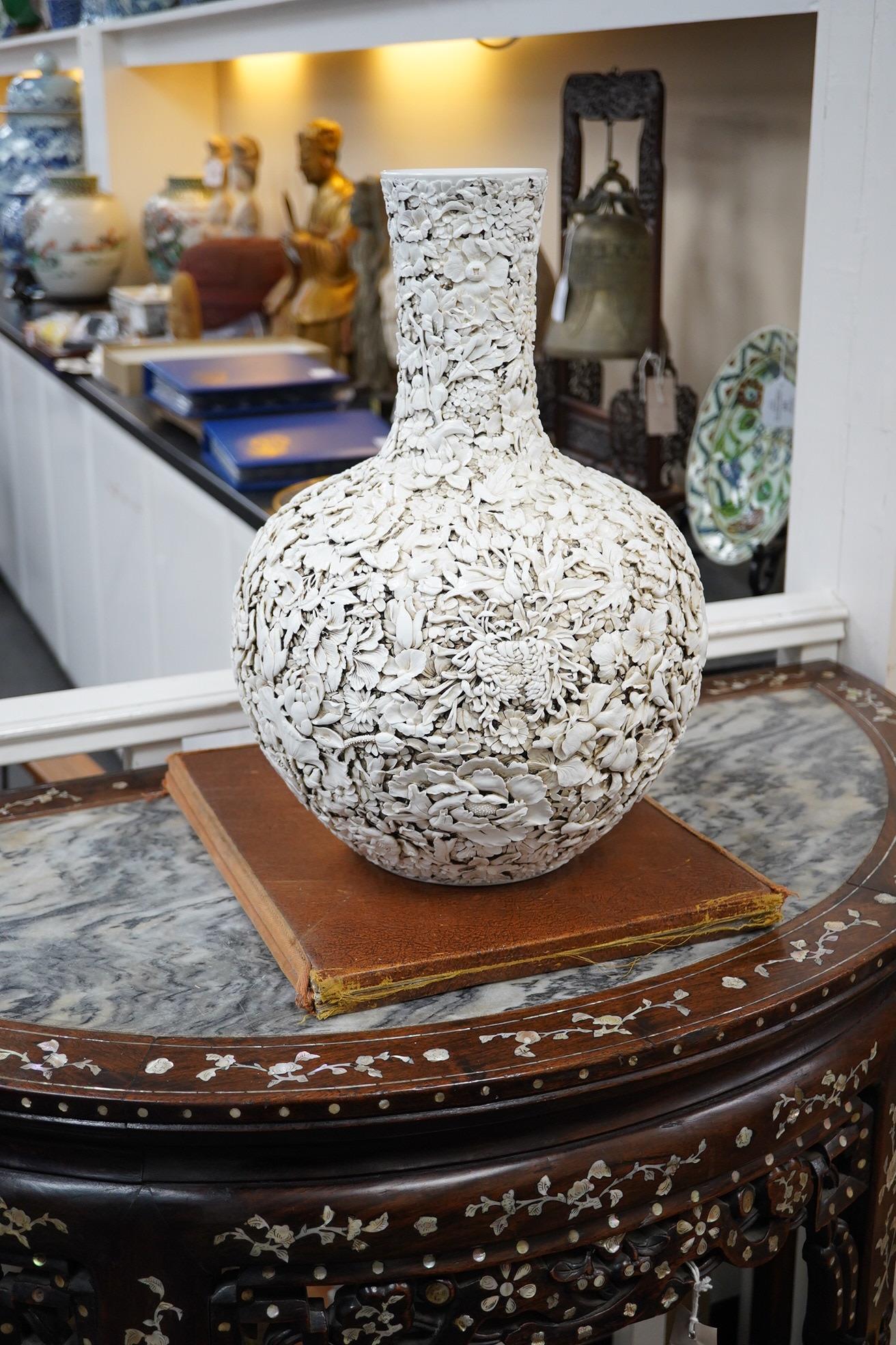 A large Chinese carved porcelain ‘thousand flower’ bottle vase, 20th century